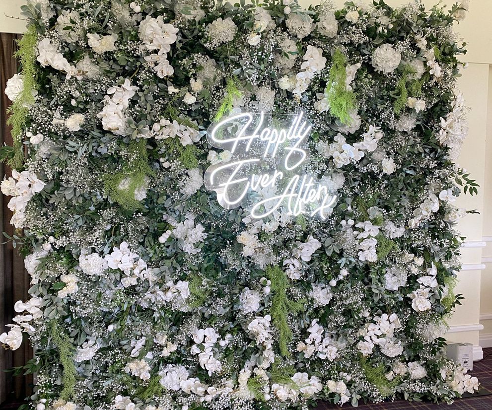 Foliage flower wall and happily ever after neon sign hire Manchester