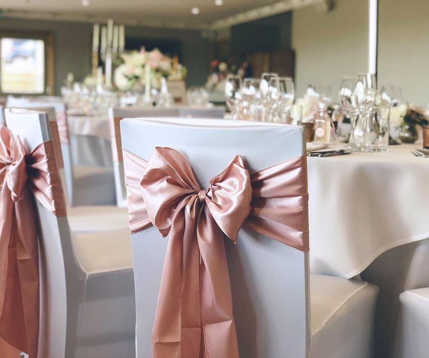 Wedding chair cover hire with blush pink chair bows in Cheshire