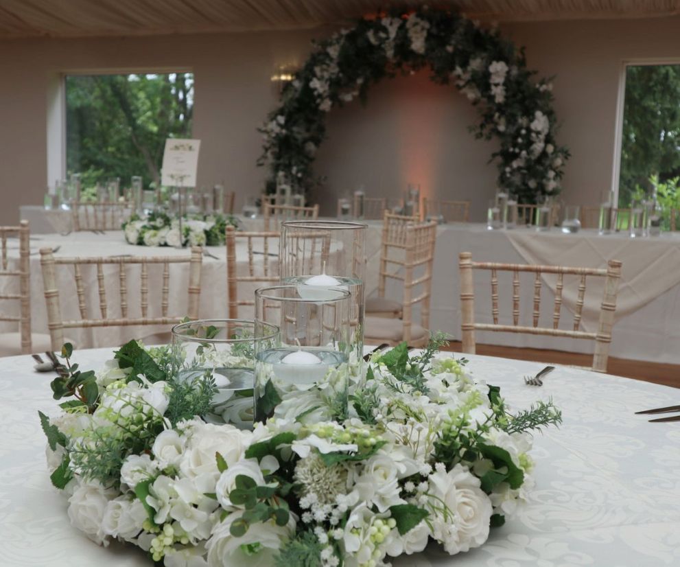 Cylinder vase centre pieces with floral wreath Wrenbury Hall