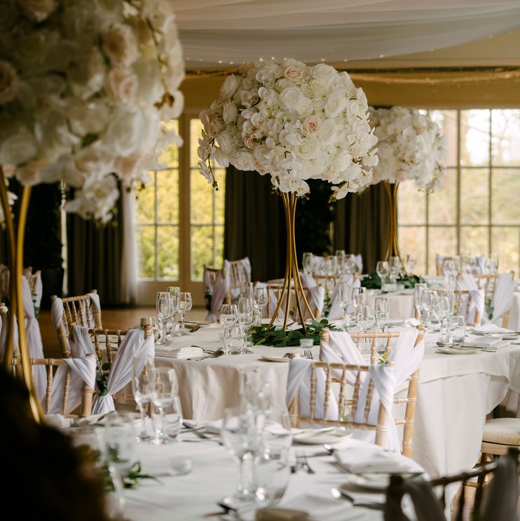 Tall white elegant wedding flowers table centre pieces in Cheshire