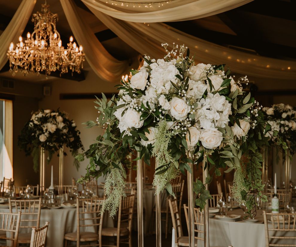 White floral centre pieces with greenery by Asha Photography Cheshire