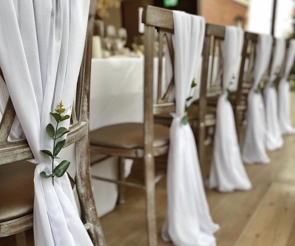 White chiffon wedding chair drapes eucalyptus venue dresser Cheshire
