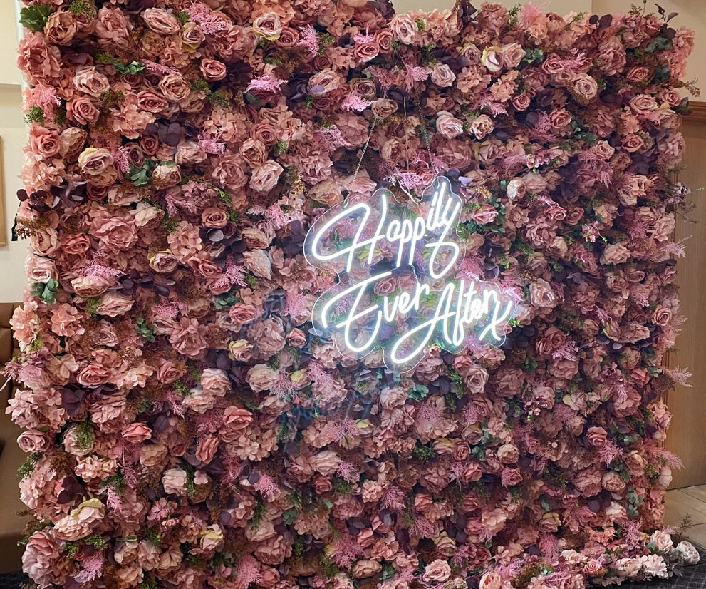 Blush pink flower wall backdrop and wedding neon sign to hire Cheshire