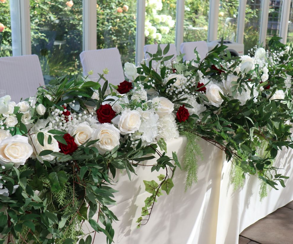 Red and white top table flowers with foliage Cheshire venue dressers