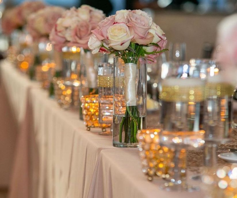 Wedding table pink flower vases with candle styling Manchester