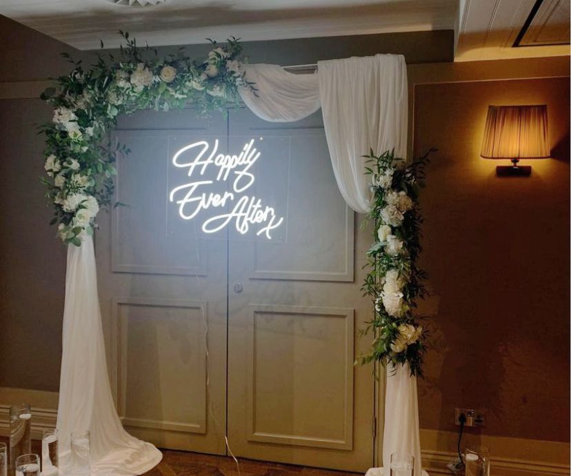 Happily ever after neon sign hire with drapes and florals Cheshire