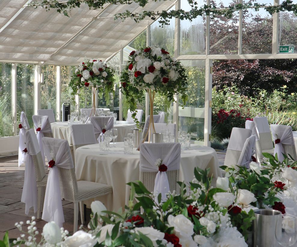 Red rose wedding centre pieces with greenery Abbeywood Estate Weddings
